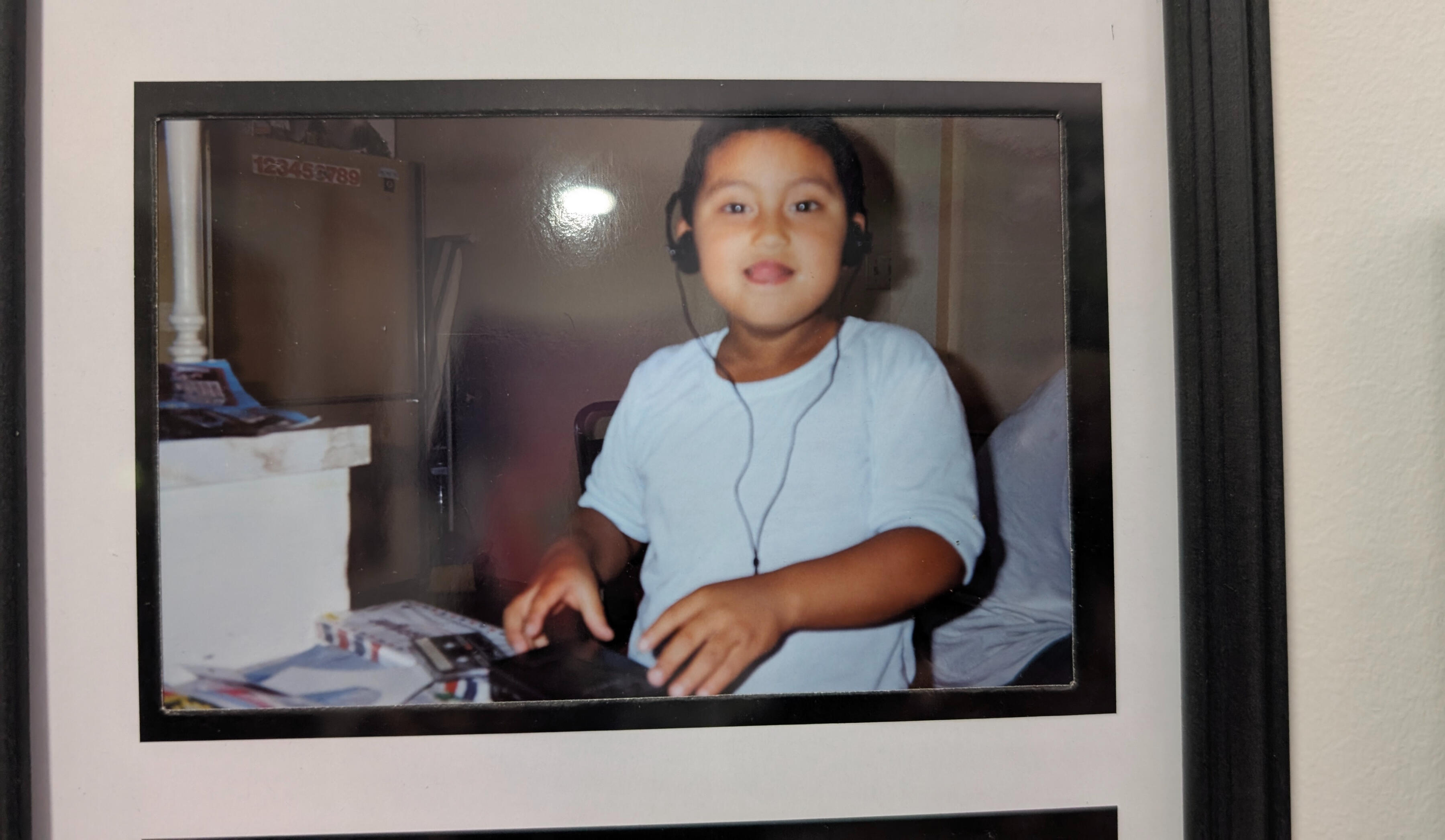 a photo of me as a young child in a white shirt.