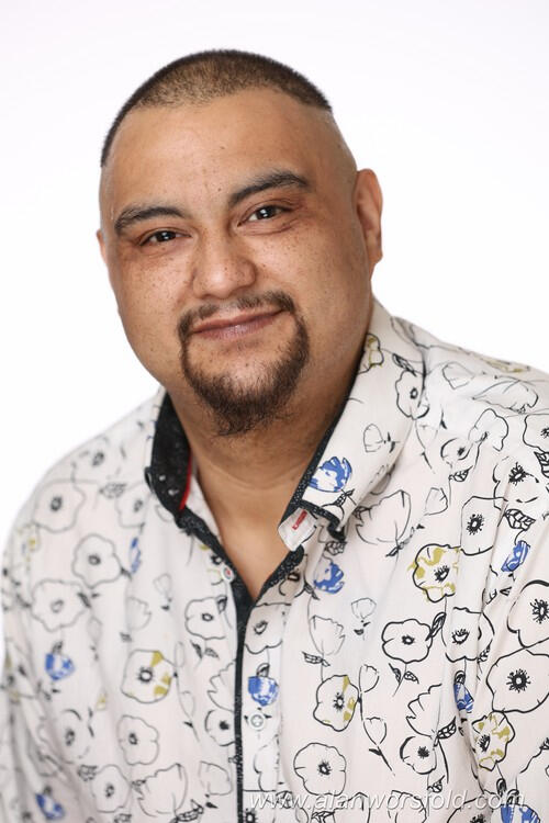 A side-by-side comparison of me at two different ages. On the left is a photo of me as a young child in a white shirt; on the right is a current portrait of me as an adult man with a goatee, wearing a floral button-down shirt.